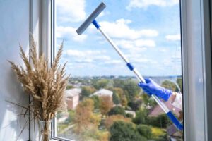 employee-hand-in-rubber-protective-glove-cleans-windows
