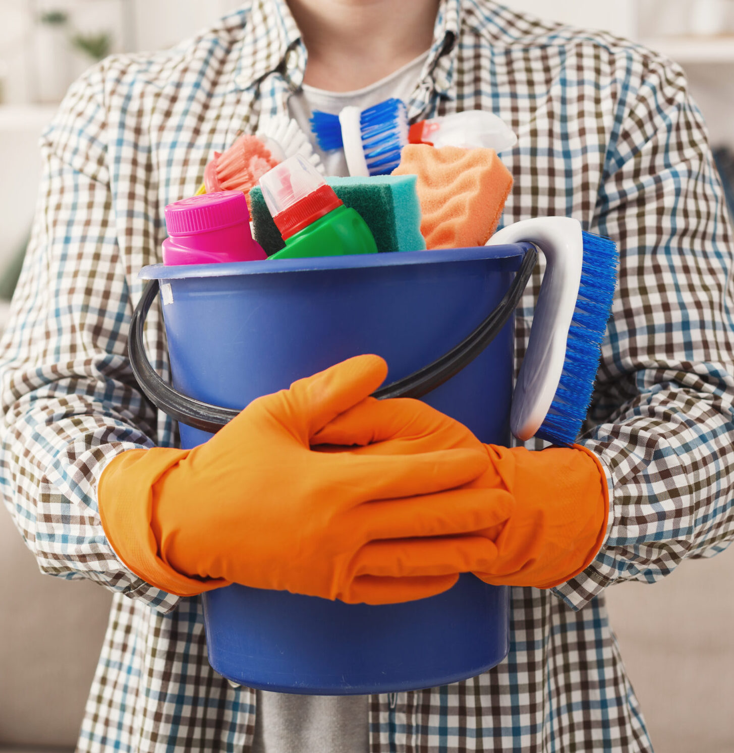 man-with-cleaning-supplies-bucket-in-bright-home-2026-04-13-03-19-34-utc